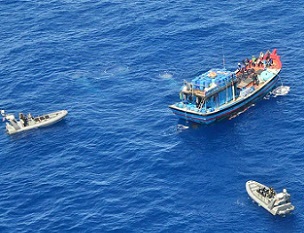 A Vietnamese illegal fishing vessel in the Coral Sea being intercepted by Australian Border Force. AAP Image/Department of Immigration and Border Protection