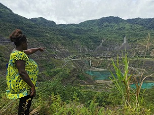 Theonila Roka Matbob stands in front of the Pangua mine in Konawiru, Bougainville. Photograph: Human Rights Law Centre/Reuters