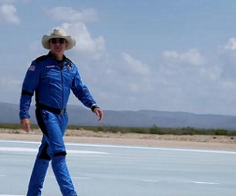 Billionaire Jeff Bezos walks on the tarmac near the Blue Origin rocket that took him to space on July 20. Credit - Joe Raedle/Getty Images