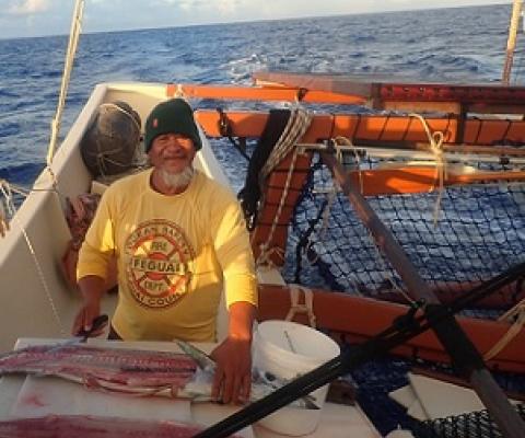 Steve aka ‘Steak’ carves up tuna for the crew of the Marumaru Atua, proving there is some fish out there? Credit - www.cookislandsnews.com