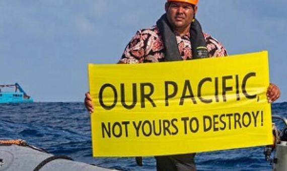 Victor Pickering, a Greenpeace activist from Fiji, in front of the Maersk Launcher, a ship chartered by DeepGreen. Photo: Supplied / Greenpeace