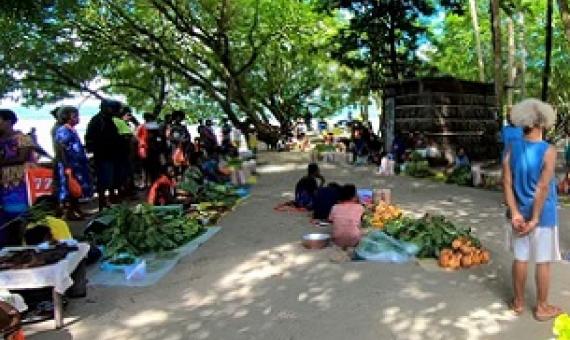People gather at the local island market. Normally, fishers sell fish at the town market, a 40 minute boat ride from Ahus island. Photo credit: Dean Miller