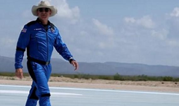 Billionaire Jeff Bezos walks on the tarmac near the Blue Origin rocket that took him to space on July 20. Credit - Joe Raedle/Getty Images
