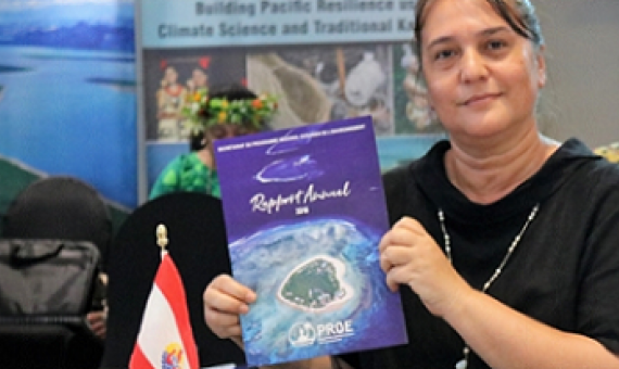 SPREP Meeting delegate holding SPREP 2018 annual report