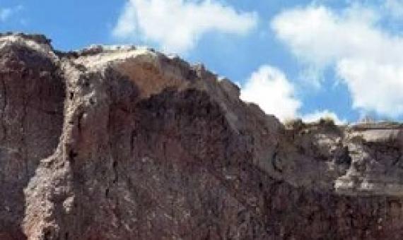 URI graduate student Reilly Hayes (left) and undergraduate Amanda Bednarick examine an outcrop for fossils at Petrified Forest National Park as part of their research. Credit: Amanda Bednarick