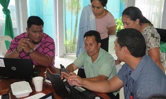 participants discussing input of field spatial data to QGIS software. Credit - V. Jungblut, SPREP