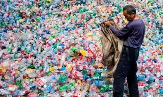 A Chinese labourer sorting out plastic bottles on the outskirt of Beijing. Photograph: Fred Dufour/AFP/Getty Images